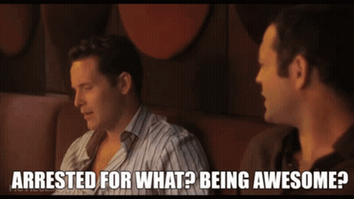 Two Men Sitting One Says Arrested For What Being Awesome GIF