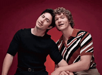 Two Men Sitting Side By Side GIF