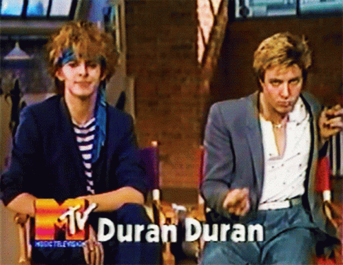 Two Men Sitting Together With Duran Duran GIF