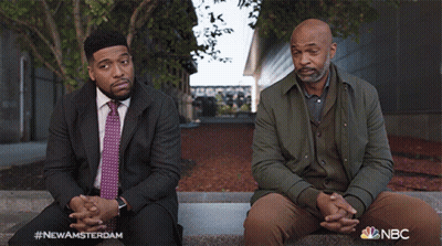 Two Men Sitting With NBC GIF