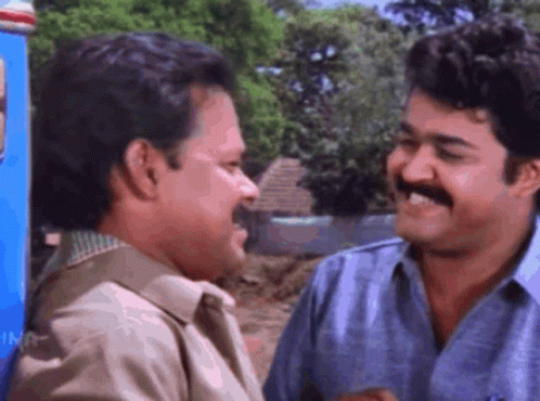 Two Men Smiling Next To Each Other GIF
