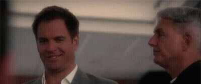 Two Men Smiling Side By Side GIF