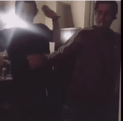 Two Men Smoking Cigarettes In Dark Room GIF
