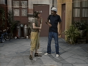 Two Men Stand In Front Of A Building With The Number 14 On The Door GIF