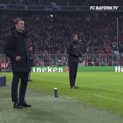 Two Men Stand On A Soccer Field In Front Of A Heineken Ad GIF