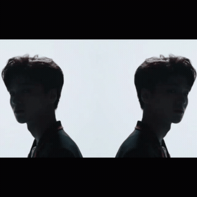Two Men Standing And Looking At Each Other GIF