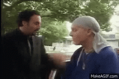 Two Men Standing And Talking GIF