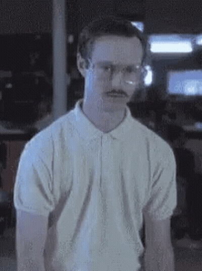 Two Men Standing And Talking In A Room GIF