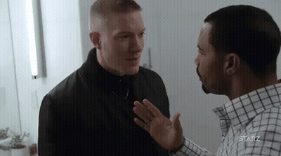 Two Men Standing And Talking In Room GIF