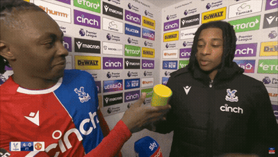 Two Men Standing Before Cinch Ad Wall GIF