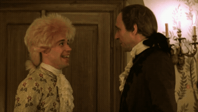 Two Men Standing Beside Candles On Wall GIF