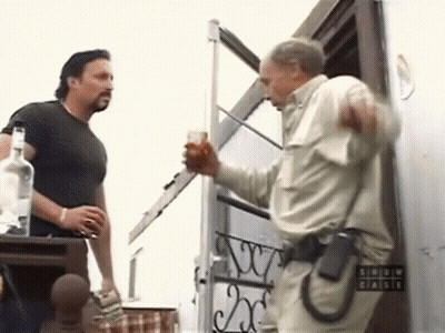Two Men Standing By Arrow Chaise Sign GIF