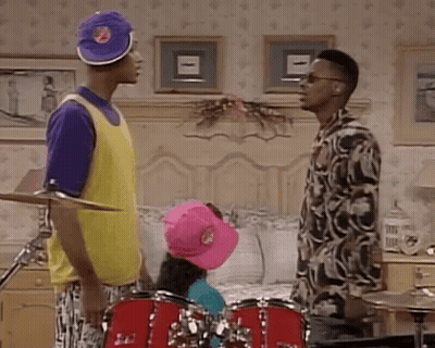 Two Men Standing By Drum Set In Bedroom GIF
