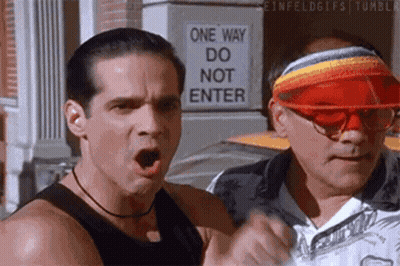 Two Men Standing By One Way Do Not Enter Sign GIF