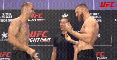 Two Men Standing By UFC Light Night Sign GIF