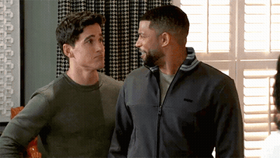 Two Men Standing By Window One Wearing Patagonia Jacket GIF