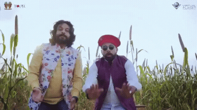Two Men Standing In A Field With Virtual Planet Written On The Bottom Right GIF