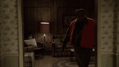 Two Men Standing In A Kitchen With A Bottle Of Liquor On The Counter GIF
