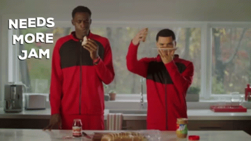 Two Men Standing In A Kitchen With The Words " Needs More Jam " Written Above Them GIF