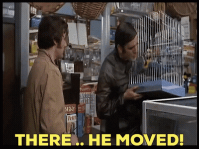 Two Men Standing In A Store With The Words " There He Moved " On The Bottom GIF