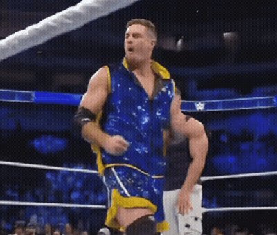 Two Men Standing In A Wrestling Ring With A Banner That Says Down On It GIF