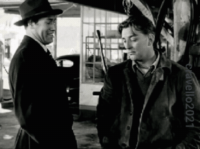 Two Men Standing in Black and White Photo by Travelo24