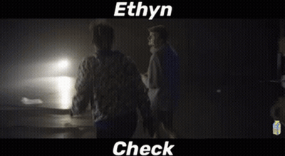 Two Men Standing In Dark Room GIF