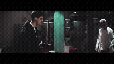 Two Men Standing In Dark Room GIF
