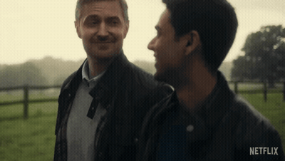 Two Men Standing In Field With Netflix Logo GIF