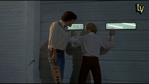 Two Men Standing In Front Of A Garage Door With Another Cherry Boys Written On The Bottom GIF