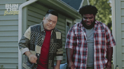 Two Men Standing In Front Of A House With The Words Run The Burbs On The Bottom Right GIF