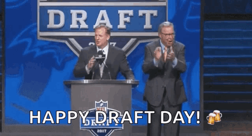 Two Men Standing In Front Of A Podium That Says Draft GIF