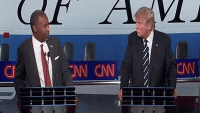 Two Men Standing In Front Of A Podium With Cnn Written On It GIF