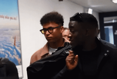 Two Men Standing In Front Of A Poster That Says ' Aerial View ' GIF