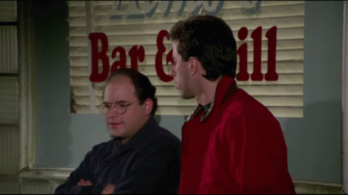 Two Men Standing In Front Of A Sign That Says Bar And Grill GIF
