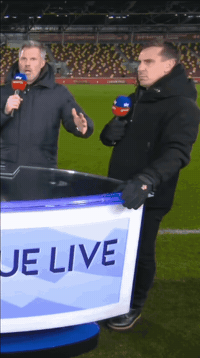 Two Men Standing In Front Of A Sign That Says ' Je Live ' GIF