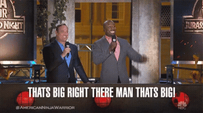 Two Men Standing In Front Of A Sign That Says " Thats Big Right There Man Thats Big " GIF
