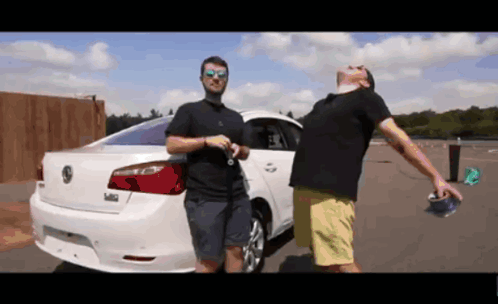 Two Men Standing In Front Of A White Volkswagen GIF