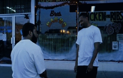 Two Men Standing In Front Of Bro's Ribs GIF