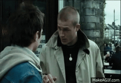 Two Men Standing In Front Of Building GIF