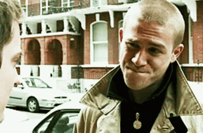 Two Men Standing In Front Of Building GIF