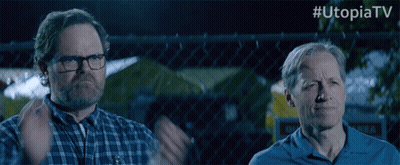 Two Men Standing In Front Of Chain Link Fence #UtopiaTV GIF