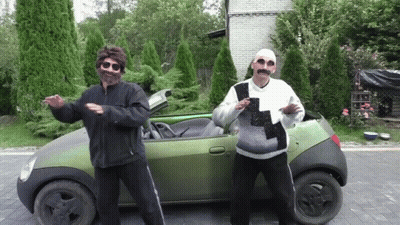 Two Men Standing In Front Of Convertible Car GIF