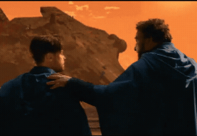 Two Men Standing in Front of Desert Mountain