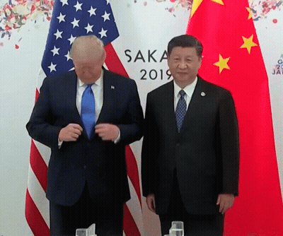 Two Men Standing In Front Of Flags With Saka 2019 On The Wall GIF