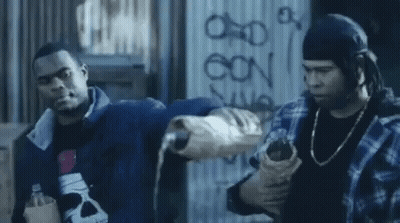 Two Men Standing In Front Of Graffiti Wall GIF