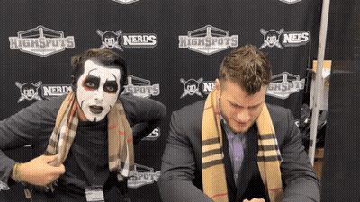 Two Men Standing In Front Of Highspots Banner GIF