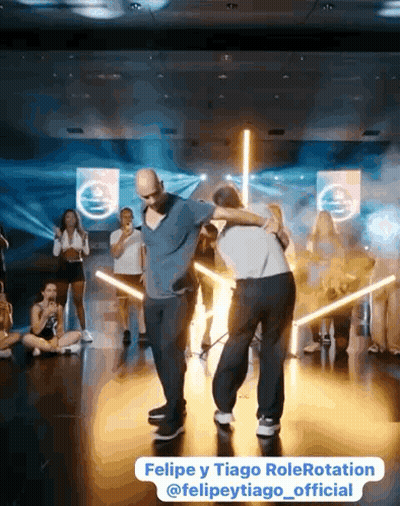 Two Men Standing In Front Of Mirror GIF