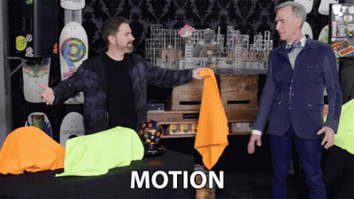 Two Men Standing In Front Of Motion Table GIF