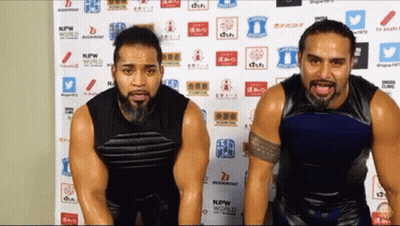 Two Men Standing In Front Of NPW World Wall GIF